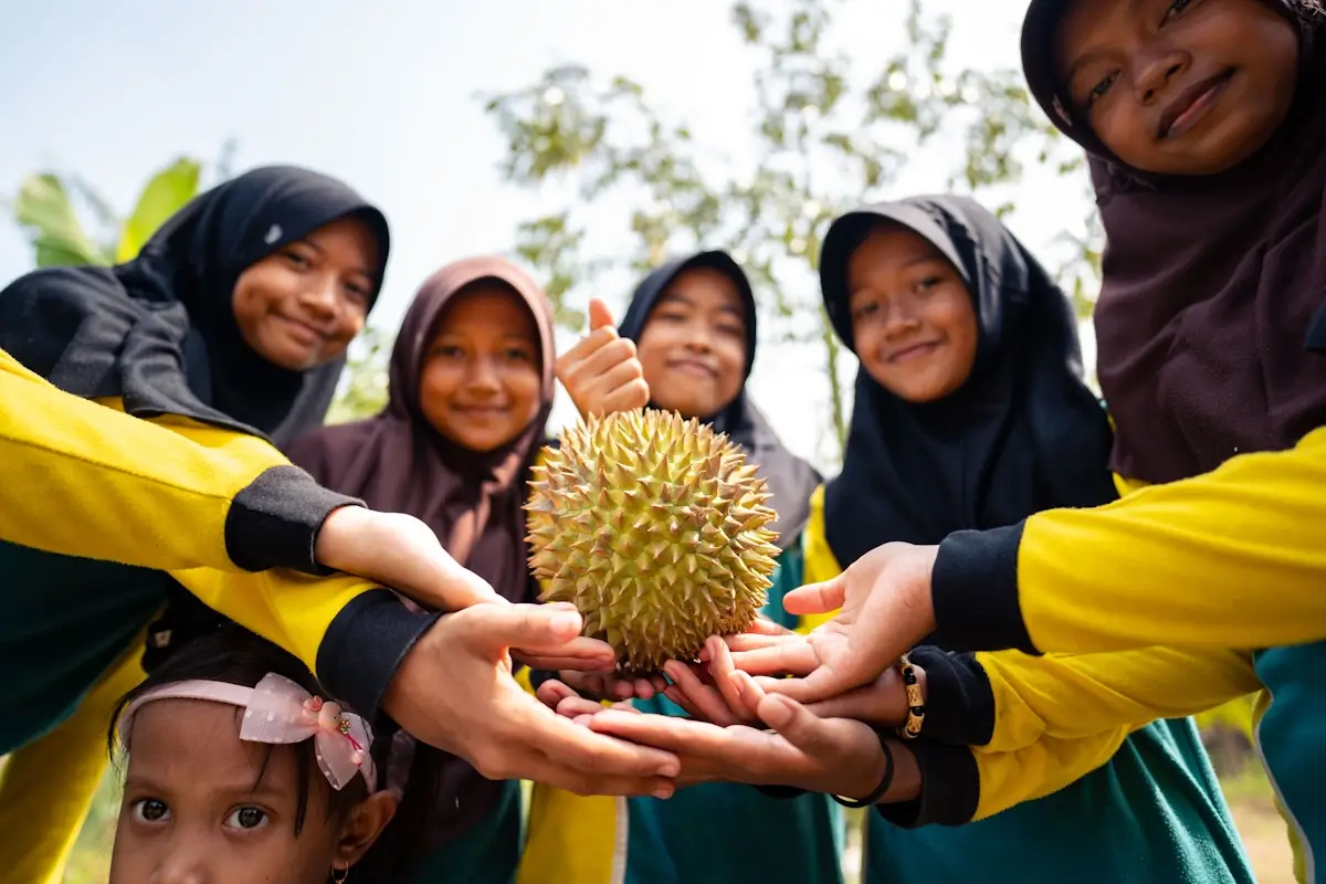 girls holding durian